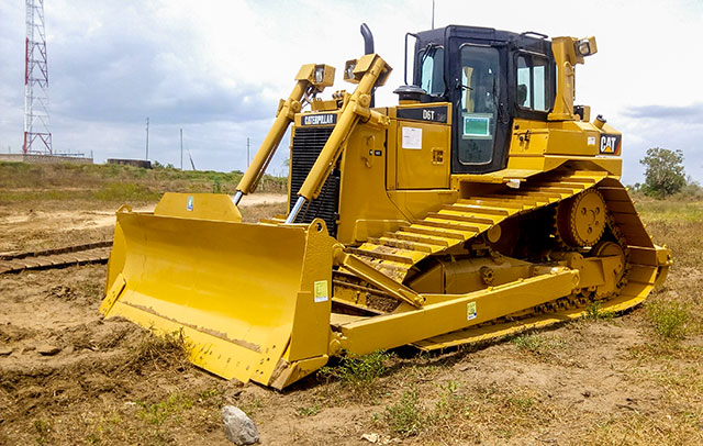 Bulldozer clearing bush and thickets